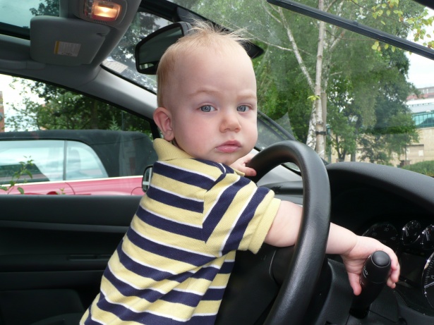 Baby behind wheel