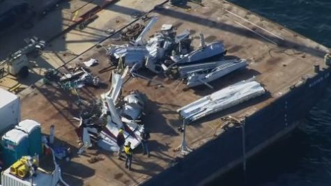 debris of the float plane on the deck of a barge ship.