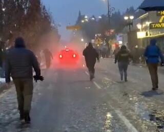 people running to stop ramped car.