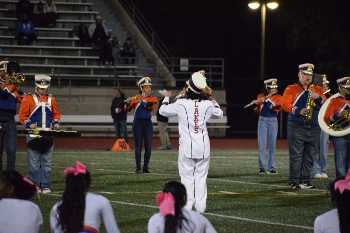 Brissisa Barajas leads the Lakes High School band in their 2024-2025 football halftime performance.